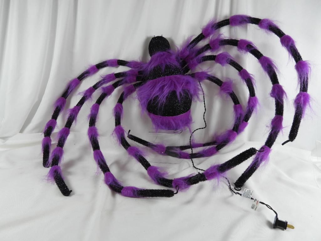 MEMBER'S MARK Porch Spider: MEMBER'S MARK Large Purple Fabric spider with 8 legs a hoop on each leg and its end so it hangs upside down illuminated eyes light up with 2 prong plug NOT TESTED L41"xW5"xH26"