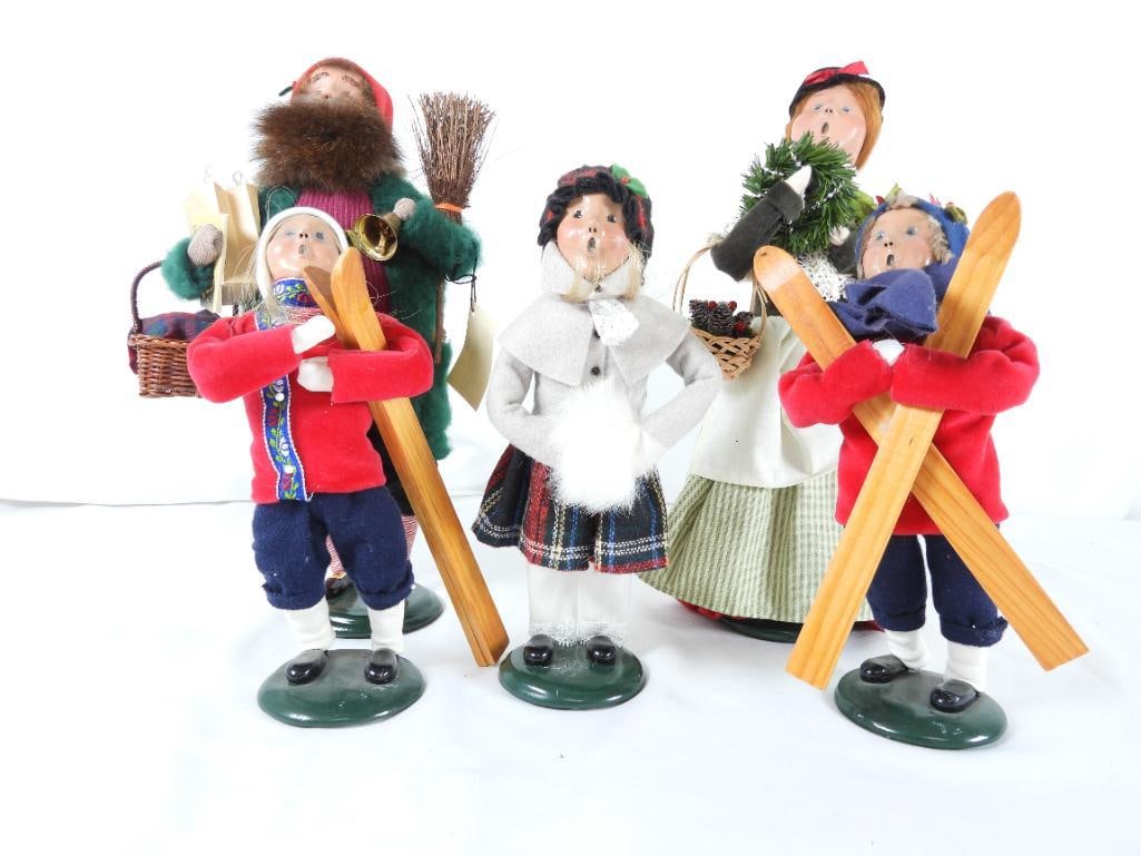 LOT OF 5 BYERS CHOICE CAROLERS FAMILY, JOYCE BYERS: LOT OF 5 BYERS CHOICE CAROLERS FAMILY: 2010 Woman caroler with poinsettia, basket of berries/pinecones and wreath, BYERS SIGNED, 6"Lx4"Wx13"T; 2007 DER BELSNICKLE JOYCE BYERS SIGNED, Around the World
