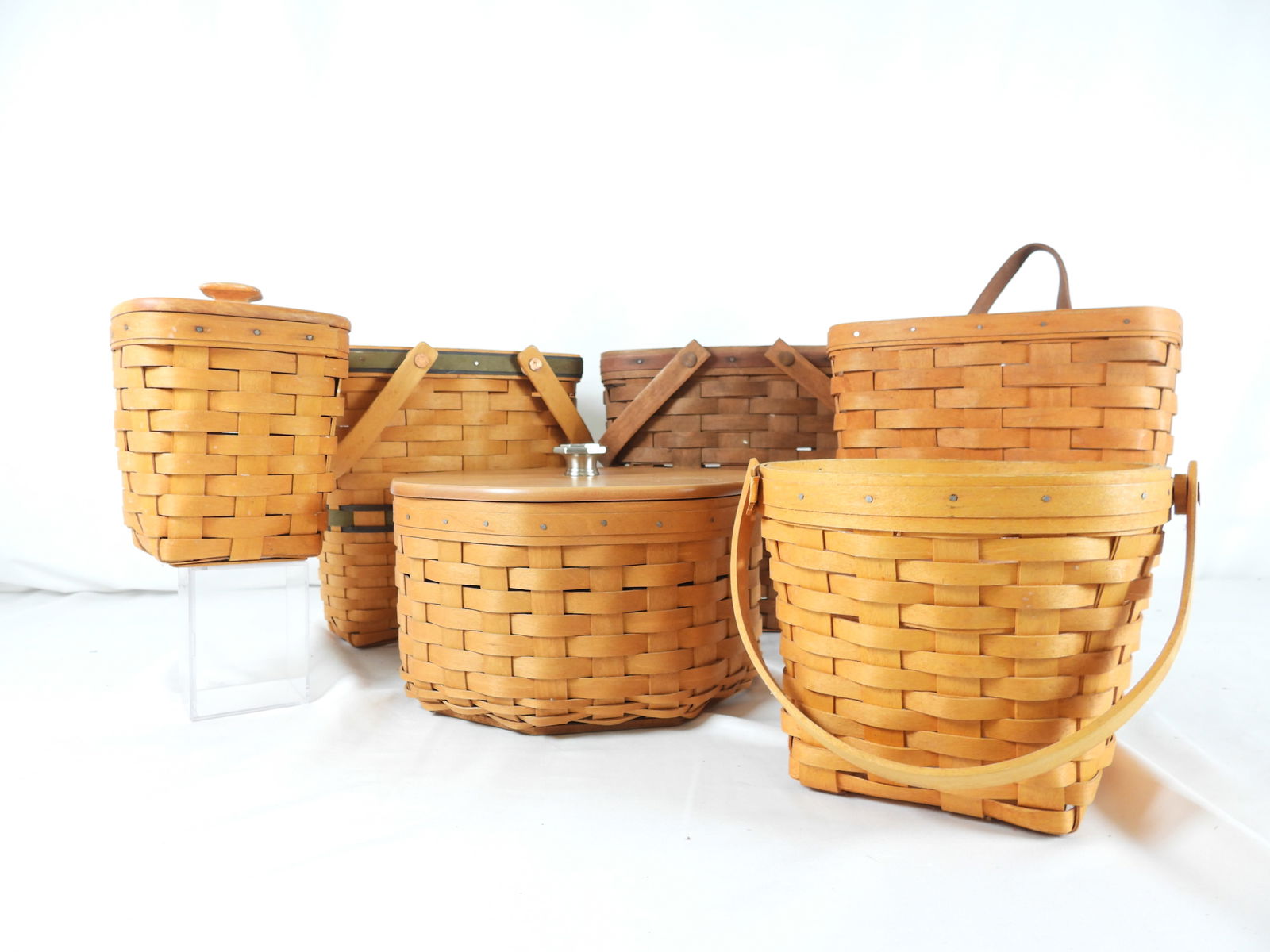 LOT OF 6 LONGABERGER Baskets, INITIALED/DATED: LOT OF 6 LONGABERGER Baskets, INITIALED/DATED: 1996 MEDIUM KEY, leather handle, protector (worn due to use); 7" MEASURING, protector, 8"Lx8"Wx6"T; 1998 PENCIL, lid 5.5"Lx5.5"Wx6"T; 1991 TALL basket wi