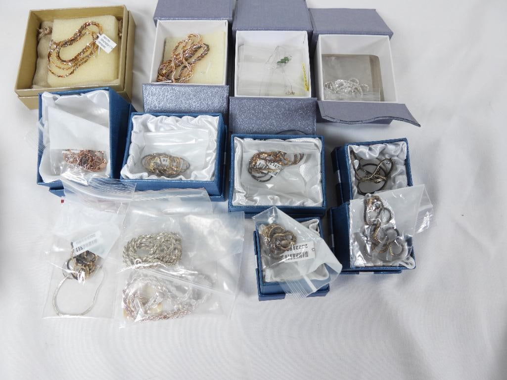 Lot of 12 sterling silver necklaces: Lot of 12 sterling necklaces. 10 are in boxes. Most are thin chains with tarnish but NEW. 2 are rope chains plus 1 small sterling bracelet.