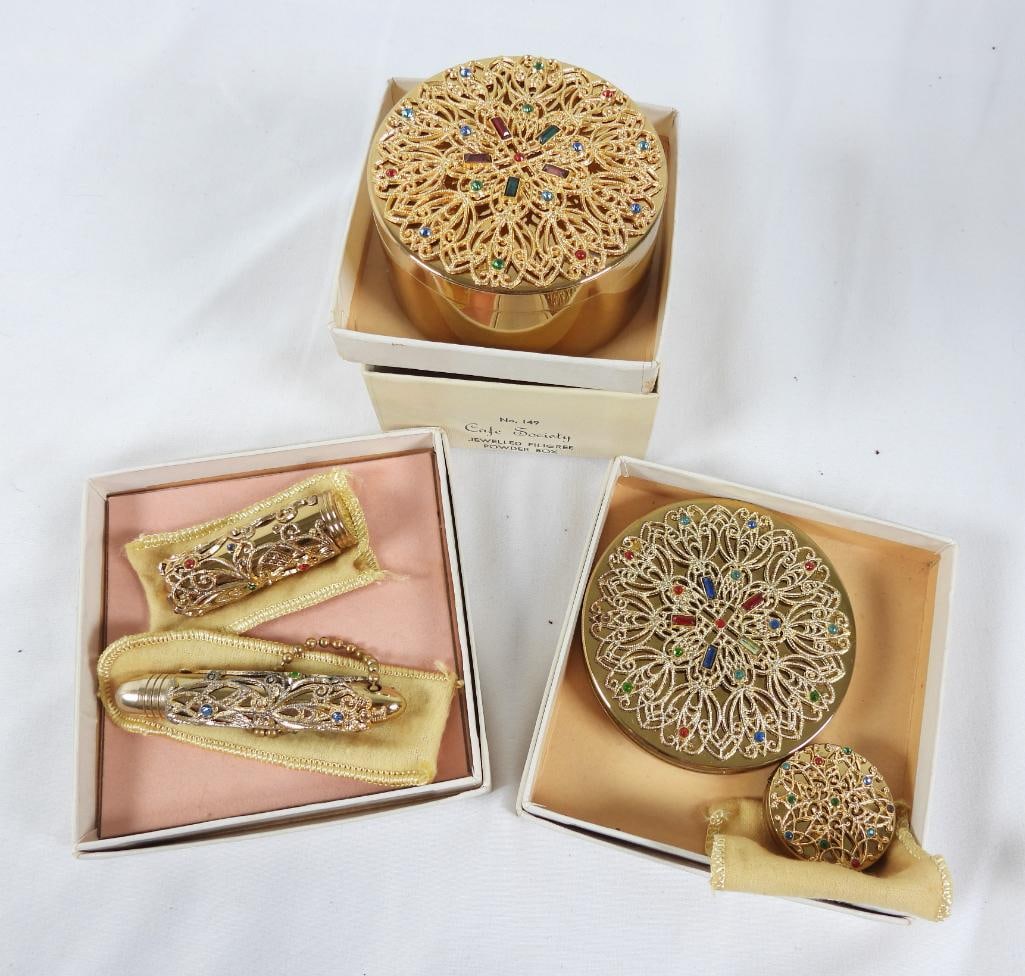 Lot of VINTAGE Cafe Society Fifth Ave NY Dresser set: Includes filigree gold and rhinestone Powder puff, compact, pill case Lipstick holder and pen holder all-in boxes except for pill box. These were distributed by HAMPDEN SALES ASSOCIATTION INC NEW YORK