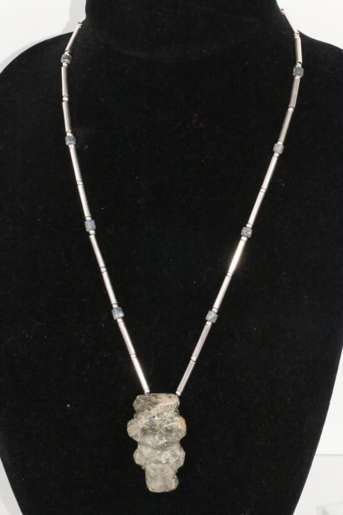 Los Castillo Taxco Mexico carved stone sterling pendant necklace: Signed Los Castillo Taxco Mexico STERLING. May be Mezcala carved stone figure pendant with large sterling tubular beads round beads and stone beads. Locking large box clasp. 22" chain. Pendant is 2" l