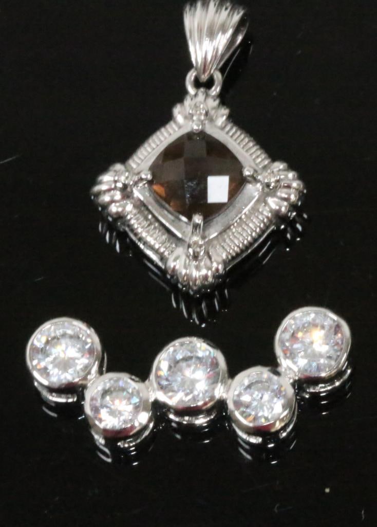 2 Sterling silver pendants including Judith Ripka Amethyst: Total weight 10.5 grams. Judith Ripka amethyst 8.2mm cushion cut pendant with a 8.2 mm with a 1.5" drop. Plus a 5 CZ pendant with large stones set in sterling silver 1.25" long.