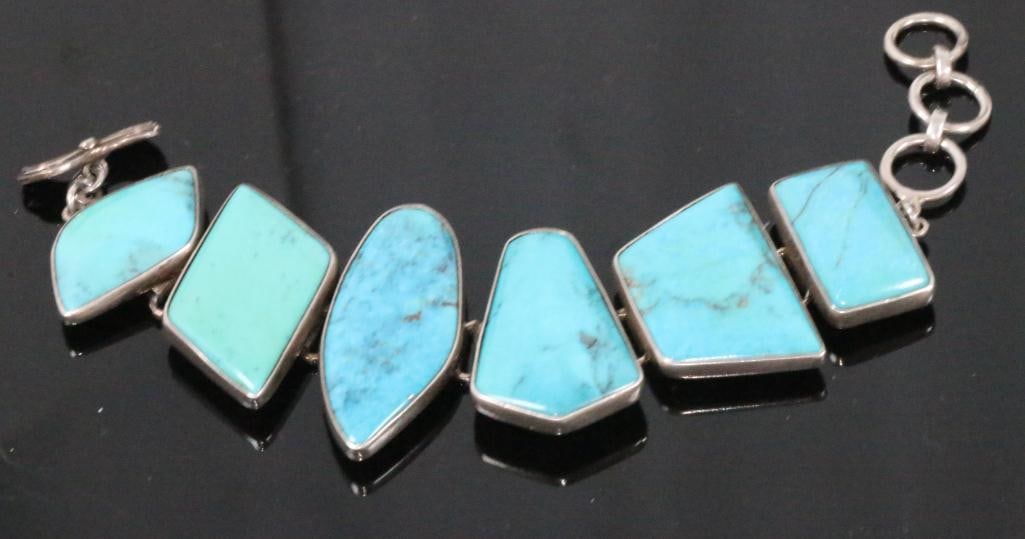 OBSIDIAN designer sterling silver huge turquoise bracelet: 70.3 grams of huge geometric shapes of varying shades of turquoise in sterling silver. Toggle closure with 3 rings. Can be worn from 7" to 8.5". Stones are large smooth polished 1.25" long x 2" longs.