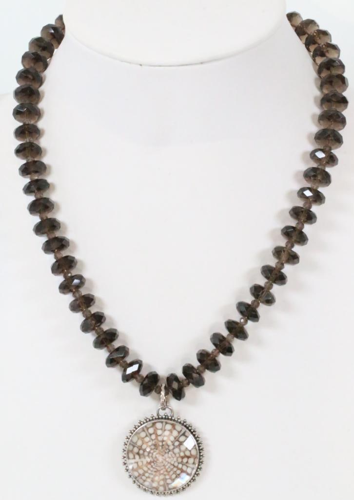 RARE Lori Bonn 200 carat Amethyst Shell Necklace: 20" Natural Spider Shell doublet pendant 52 faceted amethyst rondelles 11.71 mm each totaling approx. 200 carats of GENUINE AMETHYST plus amethyst spacers in a sterling silver setting and clasp.