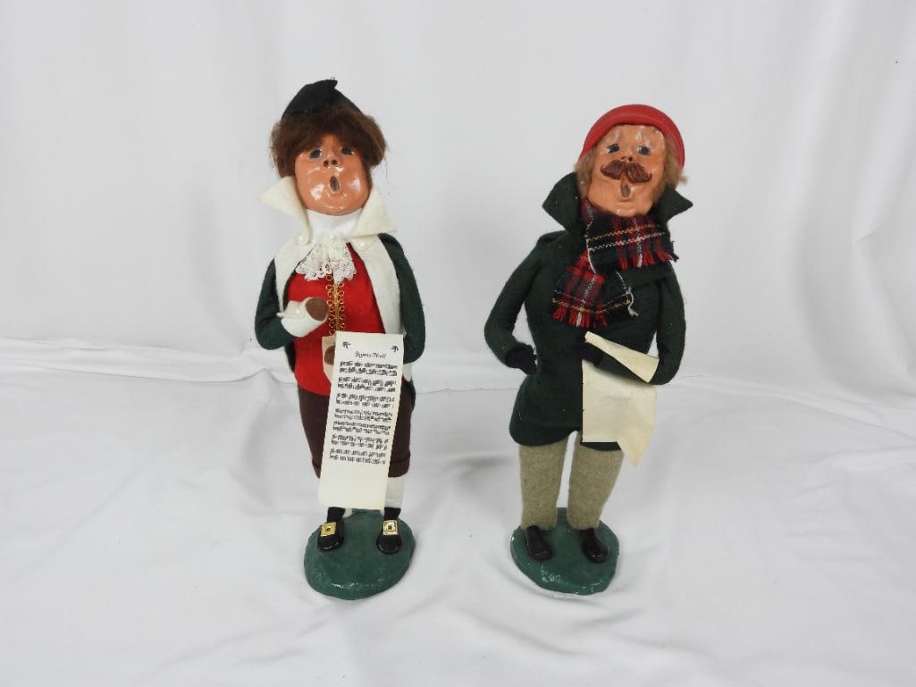 LOT OF 2 BYERS CHOICE CAROLERS 1980: LOT OF 2 COLLECTABLE BYERS CHOICE ORIGINAL CAROLERS BYERS SIGNED: 1 Caroler dressed in a green jacket with a red cap holding a music sheet 1980 L5"xW4"xH14"; 1 Caroler dressed in dated clothing with