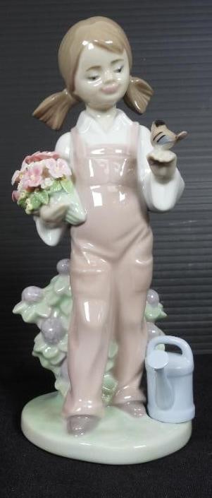 LLADRO "SPRING" Girl with flowers and bird Porcelain Figurine In original box: Made in Spain. Comes in original box. No damage. EXCELLENT CONDITION $540on Lladro Website Glossy porcelain girl figurine with pink bib coveralls holding a bouquet of flowers in one hand and a little 