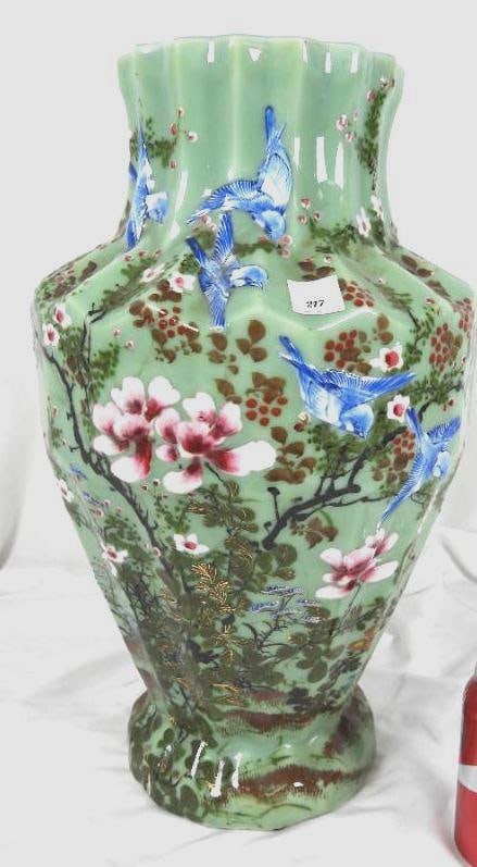 Japanese Meiji Period High-Relief Porcelain Celadon Vase 18" circa 1890-1900: Gorgeous high relief of cherry blossoms, blue swallows on a fluted Porcelain design vase. Featuring the coveted jade-green celadon glass. Details: Graceful blue swallows in mid-flight symbolizing good