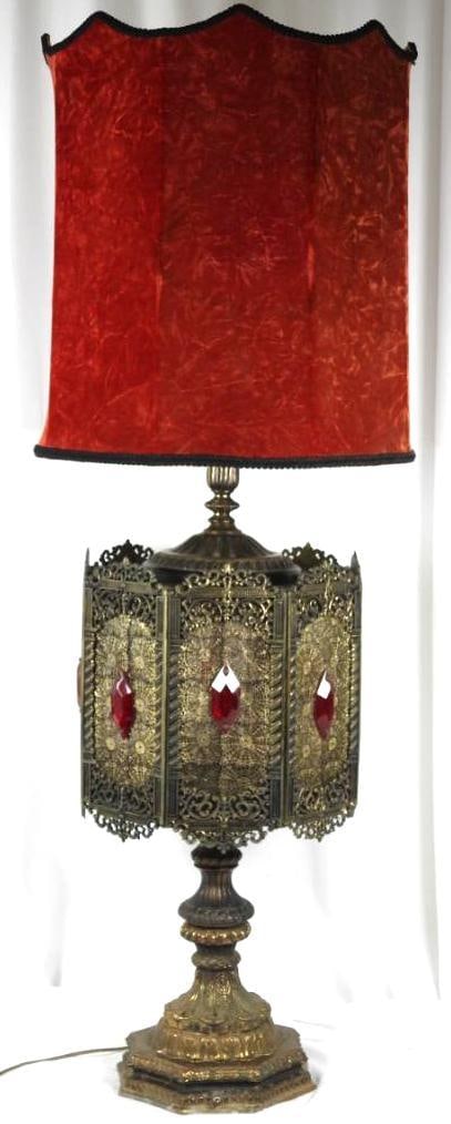 Vintage Spanish Egyptian Revival Gothic Tall Ornate Brass & red glass lamp: Spectacular HUGE lamp with the original red shade (fading and inside damage). Ruby Red glass inset Ornate filigree 8 Panel lamp Hexagonal. Lamp works. 2 way lighting lights up behind the filigree and