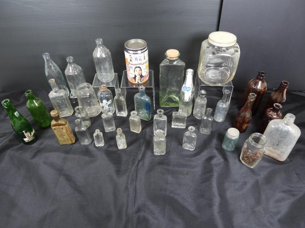 Lot of 35 vintage glass bottles and jars: Included are 14 small clear glass jars, 7 soda bottle including the Coke and Pepsi brands, 8 various household jars used for thing like furniture polish and Clorox, also included are 2 large storage j