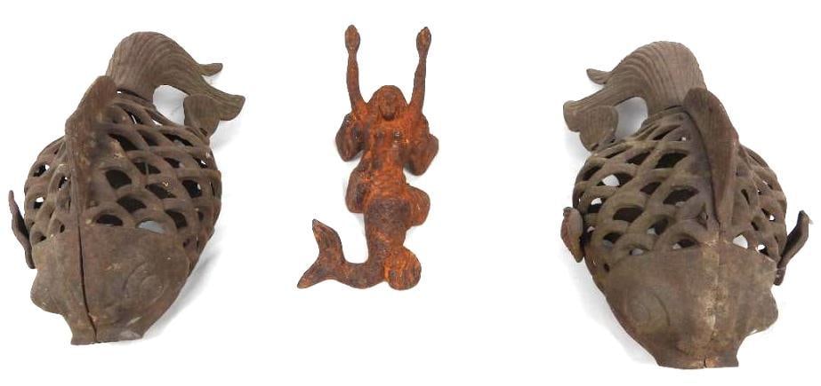 Lot of 3 iron molded patio decor: Two heavy iron fish molded to have open scale pattern are displayed and one mermaid shoe horn in good condition but is showing rust