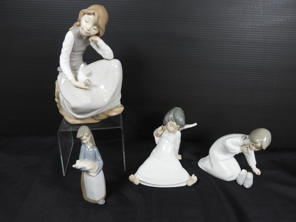 Lot of 4 Lladro Porcelain Figurines: 4 Unique female figurines each depicting a different scene of an angel sitting, a girl in plain clothing holding a piglet, a girl kneeling holding a dove on her dress and lastly a girl with a mischiev