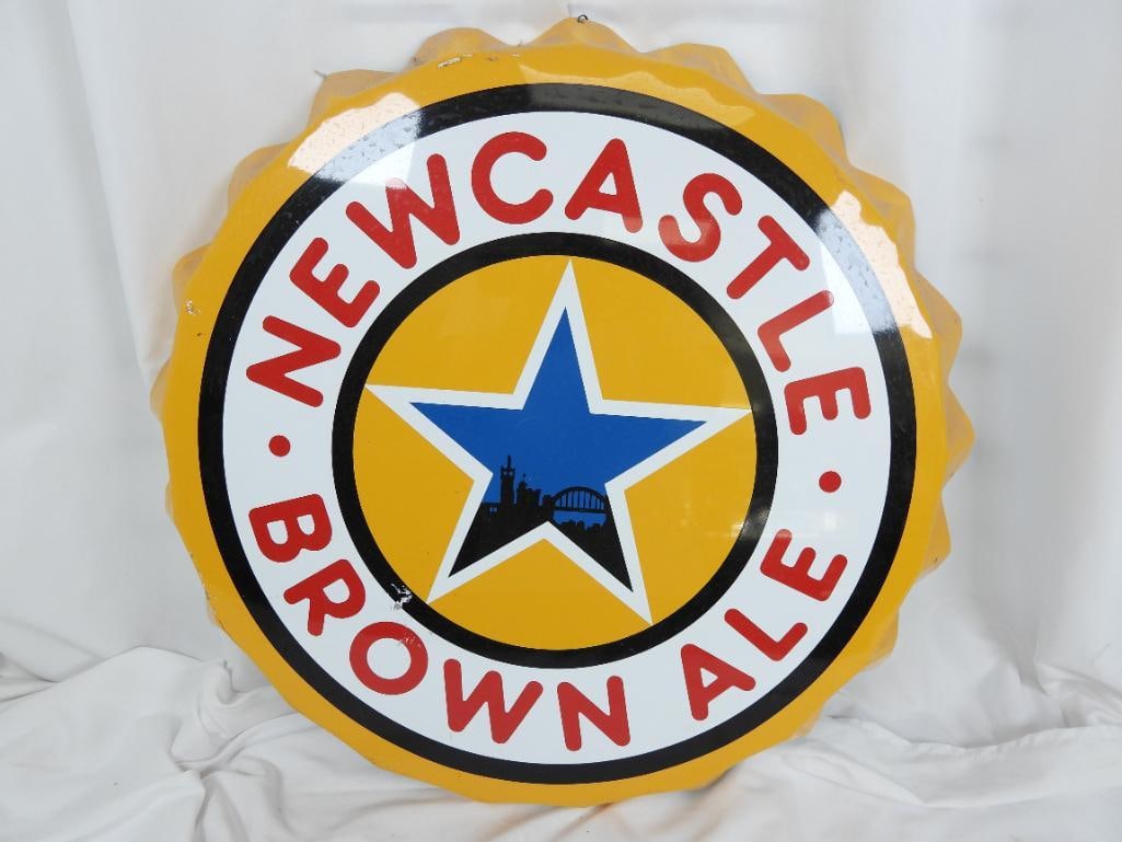 Vintage Newcastle Brown Ale sign: Made of aluminum around 22" in a classic yellow design shaped as a bottle cap perfect for a "man cave", there is a little scrape on its face by "Brown"