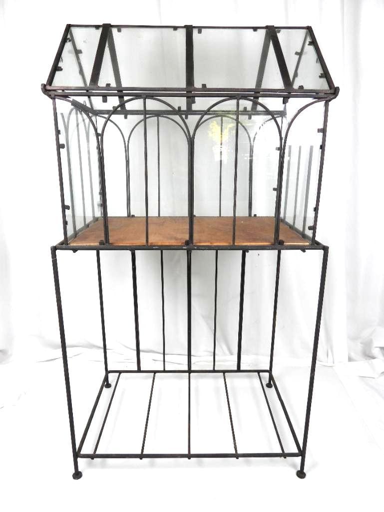 Vintage Iron and glass 2 piece terrarium: 35" total height x 18" l x 11.5 d. Top glass terrarium without the stand is 16" high to the top. Top is hinged to open. No damage to glass. Wood base to terrarium