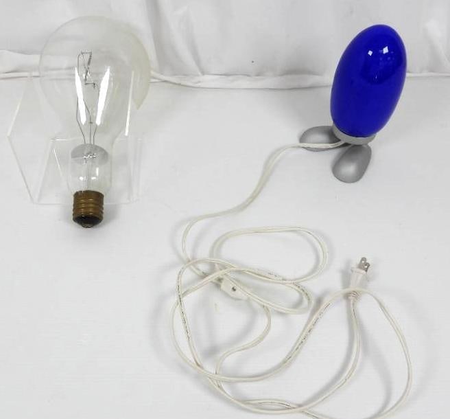 Lot of HUGE glass lightbulb and blue bullet lamp: FOR DISPLAY ONLY. CHILD SAFETY NOT GUARANTEED. WE ASSUME NO LIABILITY FOR INJURY OR ILLNESS. Blue bullet lamp with feet works. Measures: 8.5" h. Giant light bulb measures 13" h with a 6" diameter glob