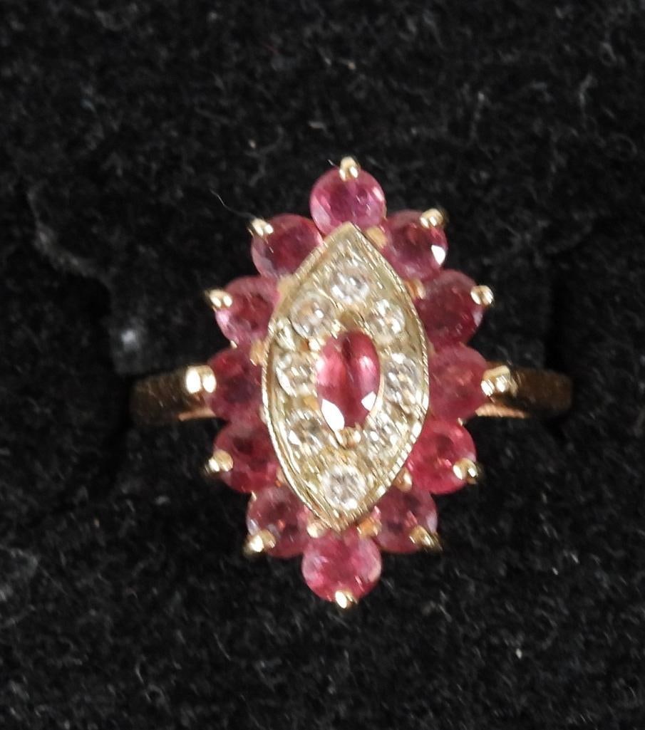 14kt gold garnet & diamond cluster ring 4.5 grams Sze: Hallmarked 14KTProng set round faceted garnets , inset diamonds and a focal prong set single diamond shape garnet center stone. Beautiful raised open gold setting