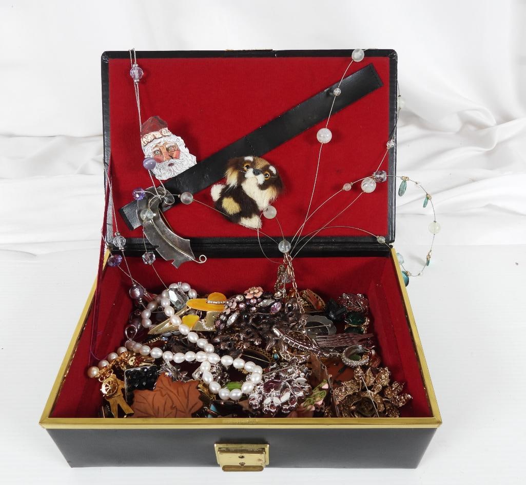 Black jewelry box with assorted costume and some vintage jewelry: Assorted costume brooches, some handmade furn cat, rhinestone, modern metal brooches and necklace.