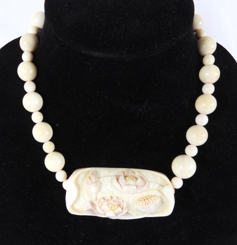 Natural Antique Carved beaded floral necklace: From a elderly woman's estate owned by her this natural bone with striations Antique necklace features prominent large lotus flower floral carved pendant and beads in time yellowing. 18" long with 3" 