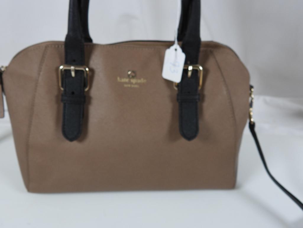 AUTHENTIC KATE SPADE Cove Street Pippa Satchel dune/Black: GUARANTEED AUTHENTIC KATE SPADE NEW YORK Cove Street Pippa Ladies Designer handbag. Features a two tone Dune dark tan and black design with patent leather handles and strap. 12"W x 8"H x approx. 5" D.