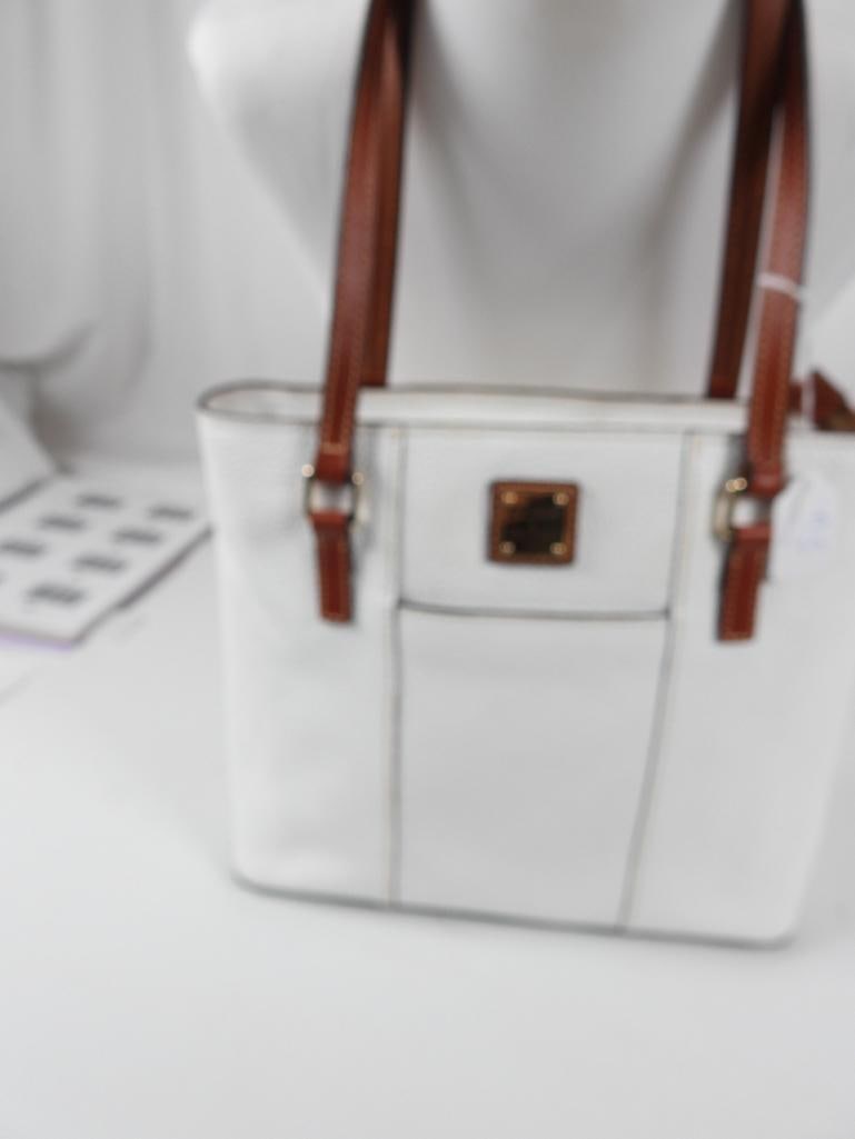 NEW AUTHENTIC Dooney & Bourke Lexington tote Handbag White: GUARANTEED AUTHENTIC DOONEY & BOURKE NEW Ladies Designer handbag in white pebbled leather with contrast brown leather handles and trim and gold tone hardware and grommet feet. Features EXTERIOR front 