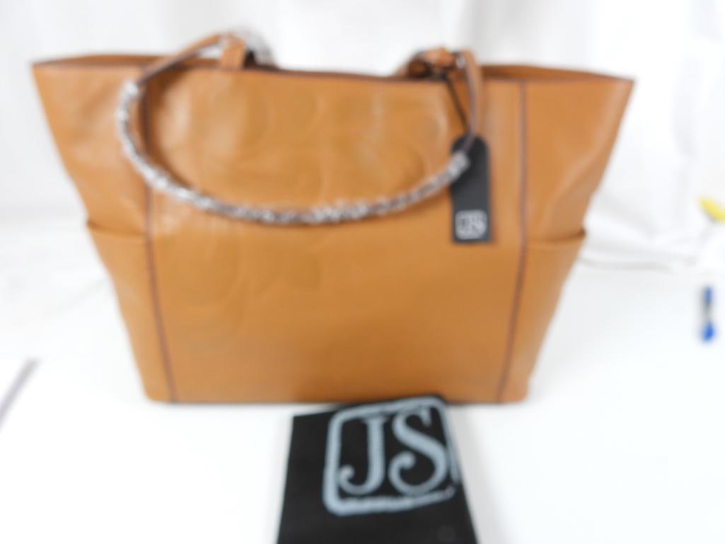 NEW LEATHER LARGE TOTE BAG by Jim Shore: GUARANTEED AUTHENTIC NEW WITH THE TAGS, Ladies Designer tote in a beautiful Caramel Tan brown leather. Features: double handles, large exterior side pockets, snap closure, lovely fabric lining in Jim