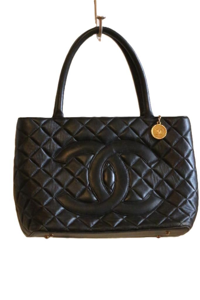 VINTAGE Chanel Quilted Medallion Handbag Tote Black Leather: Note some wear on the edges. Needs reconditioning. No rips or tears in the lather. SUEDE Leather lined. No serial number.