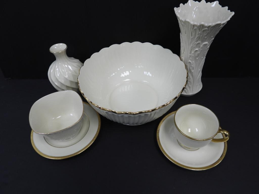 LOT OF 7 VINTAGE LENNOX VASE/TEA CUPS: Featured in this lot are 1 bud vase with gold trim 4"x4"x6", a tall Lennox woodland vase with an overlapping acanthus leaf pattern 4.5"x4.5"x8.5", a Lennox Ivory bowl from the housewarming collection 