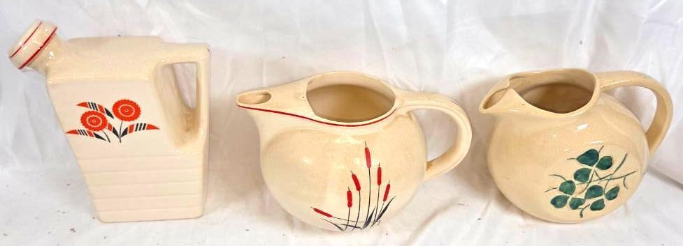LOT OF 3 VINTAGE POTTERY TEAPOTS: 3 Different teapots made by three different artists being McCoy pottery with a clover motif 9"x5"x7", Universal Pottery inc. depicting a small display of retro colored daisies on a rectangular pot wit