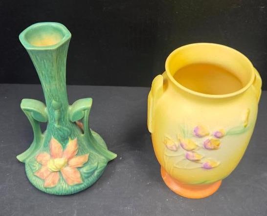 LOT OF 2 VINTAGE ROSEVILLE BUT VASES: Pottery has model number 853-6 with yellow anf purple floral motifs 4.5"x4"x6.5" and 187-7 in green with a large pink daisy like flower on its face 5"x4"x7"