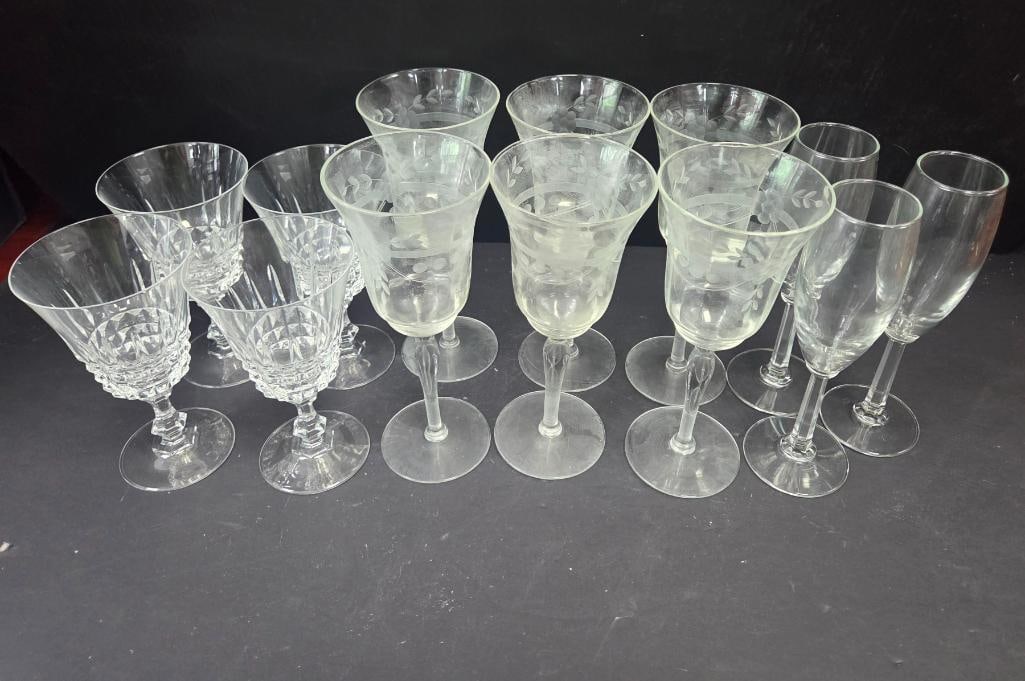 LARGE LOT OF 13 MIXED WINE/CHAMPANGE GLASSES: 6 Glasses appear to be crystal with distinct grape vine motifs about 8.5" tall all matching, 3 regular champagne glasses (possibly lennox olympia) 8" tall, and 4 Crystal goblets 6.5" tall