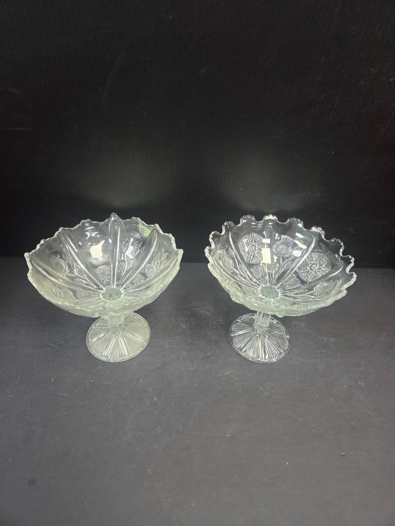Pair of Pressed Glass Thistle Pattern Footed Compotes: Matching pair of footed compotes, fan-shaped bowl with scalloped/ruffled rim, thistle and floral pattern, on a round starburst-cut pedestal foot (closely matches Lot 122). Approx. 6"H x 7"W at rim eac