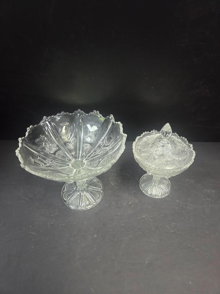 Pressed Glass Thistle Pattern Compote and Covered Candy Dish: Open footed compote, fan-shaped bowl with scalloped rim, thistle pattern, starburst pedestal foot. Approx. 6"H x 7"W at rim.Covered candy dish, thistle pattern base, matching lid with faceted teardrop