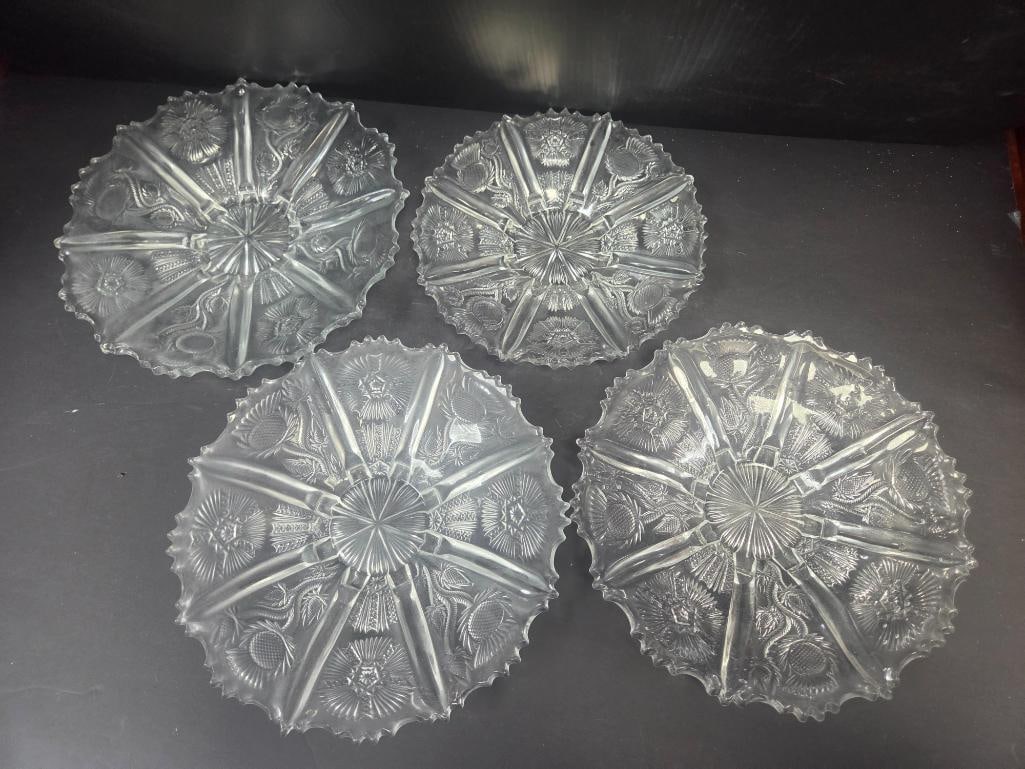 Set of Four Pressed Glass Thistle Pattern Bread Plates: Set of four matching bread/dessert plates, thistle pattern with scalloped rim. Approx. 8"W each.
