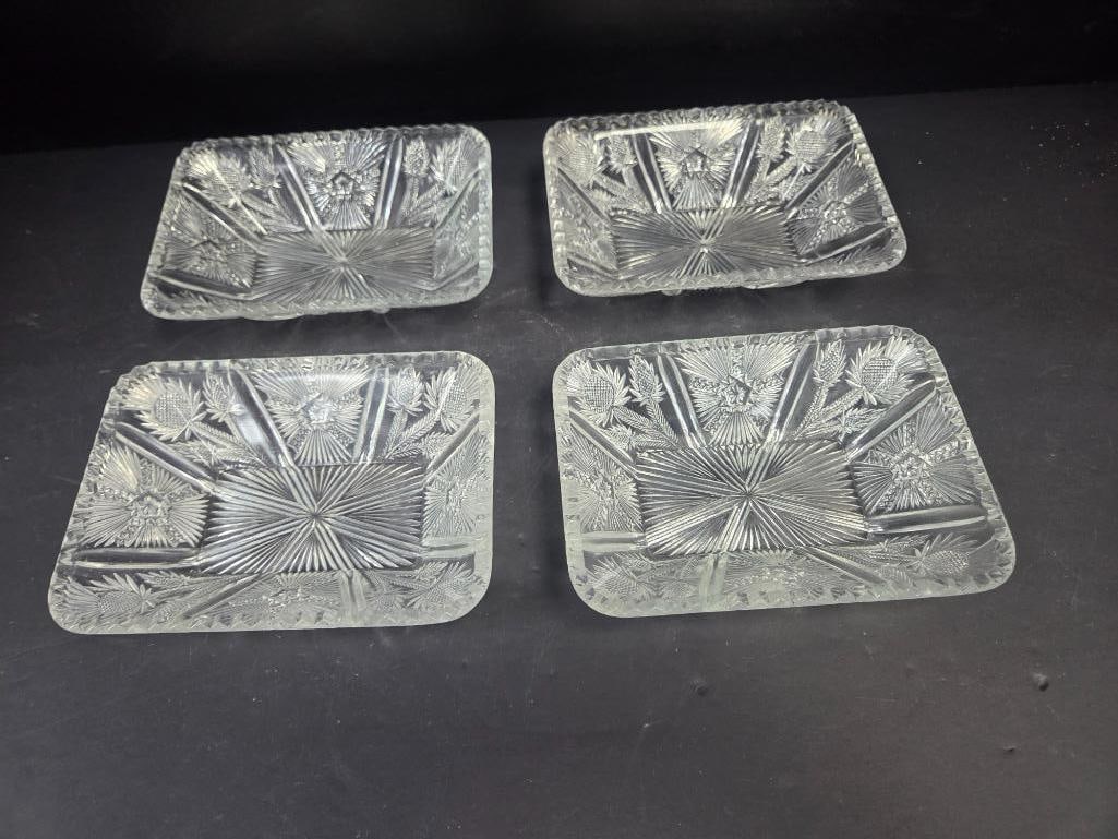 Set of Four Pressed Glass Thistle Pattern Rectangular Dresser Trays: Set of four matching rectangular dresser/vanity trays, thistle pattern with sectioned starburst center, scalloped rim. Approx. 7"L x 5"W each.