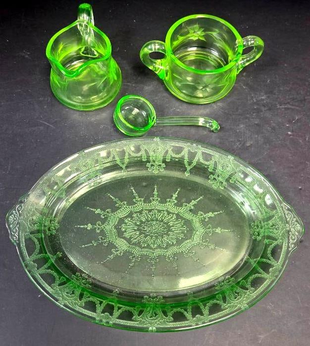 Green Depression Glass Etched Creamer, Sugar, Ladle, and Platter: Creamer, green glass, etched floral swag pattern, pinched spout, applied handle. Approx. 3.5"H x 4"W.Open sugar bowl, matching etched pattern, two applied handles. Approx. 3"H x 5"W.Small ladle, match
