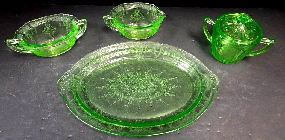 Green Depression Glass Etched Sauce Dishes, Platter, and Covered Sugar: Small oval sauce/gravy dish, green glass, etched floral swag pattern, two tab handles. Approx. 2"H x 6"W.Small oval sauce/gravy dish, matching pattern, pinched spout, two tab handles (differs slightly