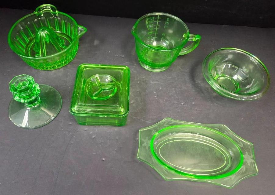 Grouping of Six Green Depression Glass Kitchenware Pieces: Citrus reamer/juicer, green glass, handled bowl with ribbed cone. Approx. 3"H x 7"W.Measuring cup, green glass, embossed measurement lines, applied handle. Approx. 5"H x 6"W.Square covered butter/refr