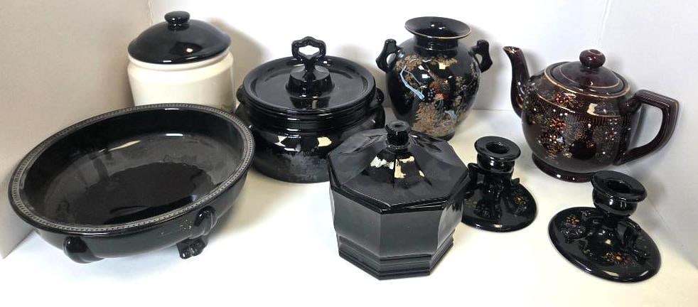 Mixed Grouping of Black Glass and Pottery Serving Pieces: Oval footed bowl, black glass, beaded rim, three feet. Approx. 3"H x 10"W.Covered canister, white body with black lid and knob finial. Approx. 7"H.Covered casserole dish, black glass, knob finial. App