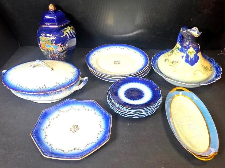 Mixed Grouping of Blue and White China: Covered ginger jar, cobalt blue ground with painted Asian-style landscape scene, gilt finial. Approx. 10"H.Covered oval vegetable tureen, flow-blue floral pattern, handled. Approx. 6"H x 11"W.Approx.