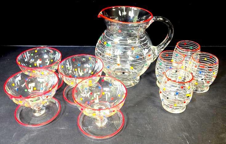 Nine-Piece Polka Dot Glass Beverage Set: Pitcher, clear glass with red rim and multicolor polka-dot and stripe design. Approx. 8"H.4 matching footed sherbet/dessert cups, same polka-dot design. Approx. 3.5"H each.4 matching tumblers, same
