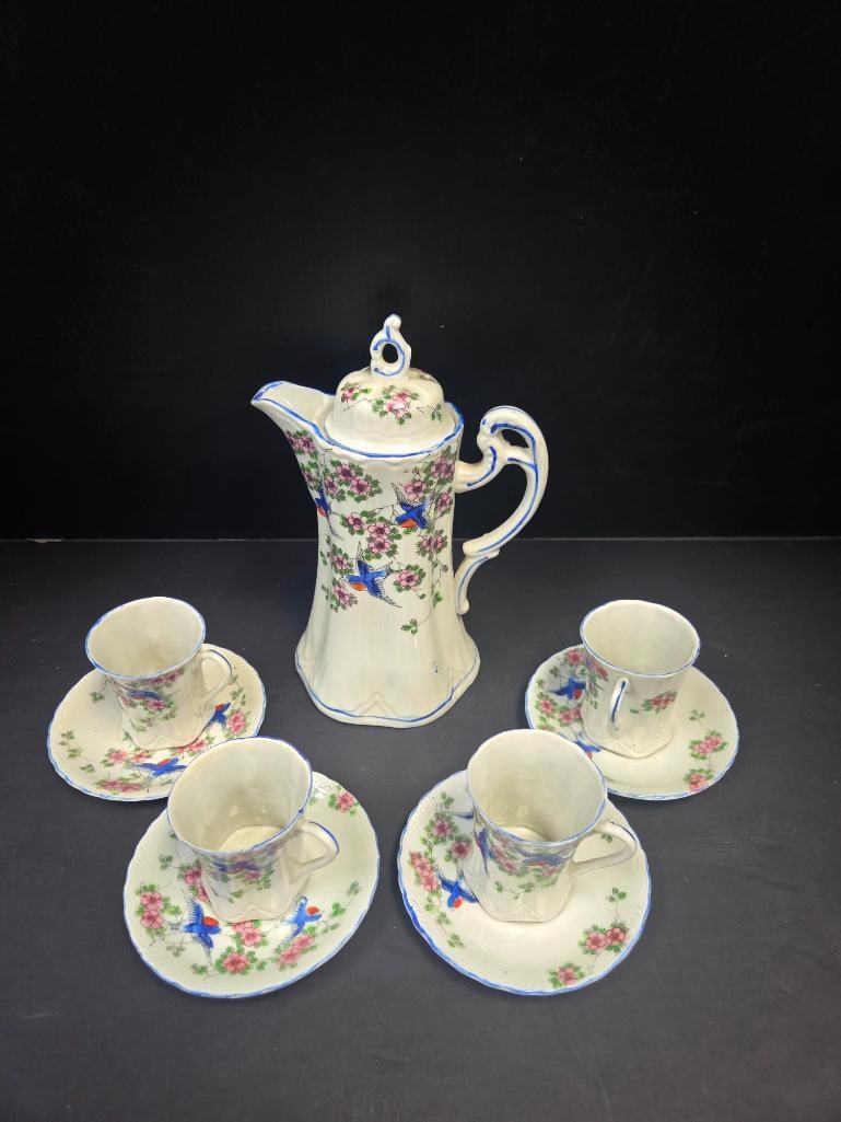 Nippon-Style Hand-Painted Chocolate Pot Set, Five Pieces: Hand-painted porcelain chocolate pot in Nippon style with pink floral and blue swallow/bird motif and ornate scroll handle, together with four matching cups and saucers in the same pattern, genuine ma