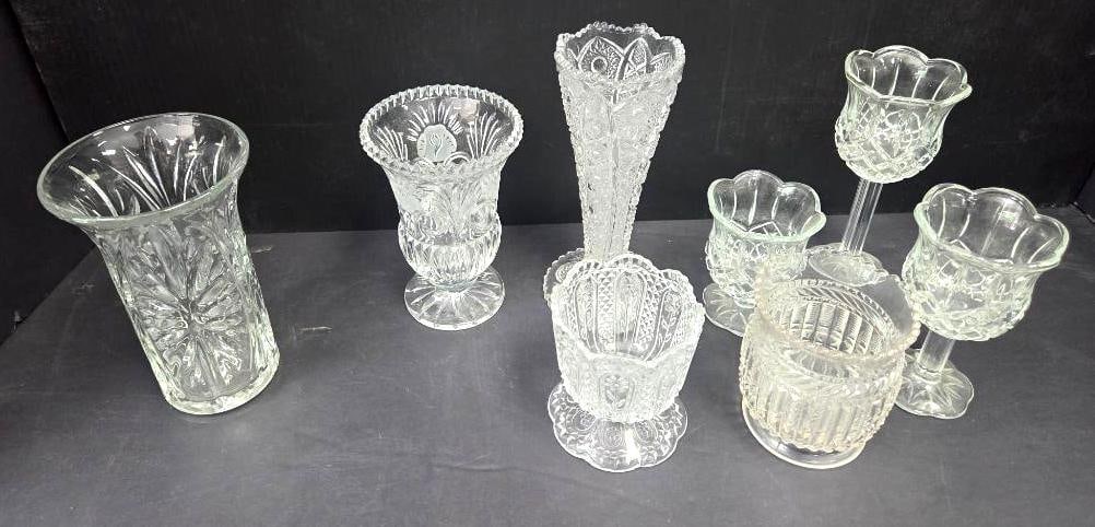 Assorted Pressed Glass Vases, Compotes, and Candle Holders, Large Grouping: Tall pressed glass vase with pinwheel/star-cut pattern, flared rim, approx. 9" H; pressed glass footed urn-form vase with fan pattern, approx. 6" H; tall pressed glass trumpet vase with cut floral