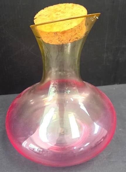 Pink Opalescent Glass Cruet: Pink opalescent glass cruet/carafe with cork stopper and amber-tinted neck, approx. 7" H x 5" diameter base.