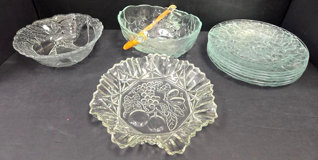 Pressed Glass Bowls and Plate Set: Pressed glass bowl with grape and leaf pattern, approx. 8" diameter, no maker's mark visible; green-tinted pressed glass ruffled nappy dish with amber/wrapped rattan-style handle, approx. 6"