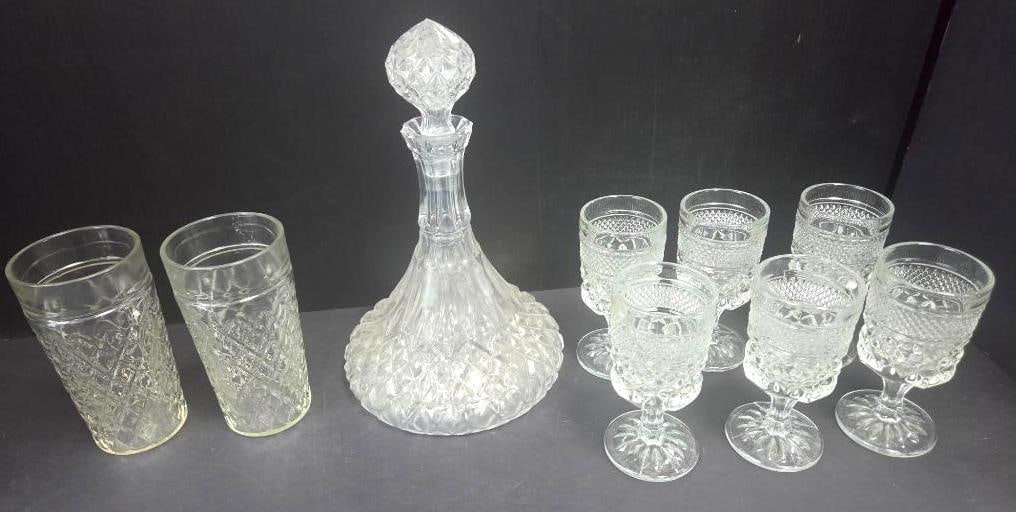 Pressed Glass Barware Set, Nine Pieces: Pressed glass decanter with faceted diamond-point stopper and matching diamond-point body, approx. 11" H, together with two matching pressed glass tumblers in the same diamond pattern, approx. 5" H,
