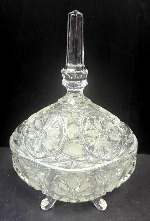 Cut Crystal Footed Covered Candy Dish: Pressed crystal footed covered candy dish with hobstar and floral-cut relief pattern, oval form with knob finial lid, raised on four small feet, approx. 6" H x 6" W.