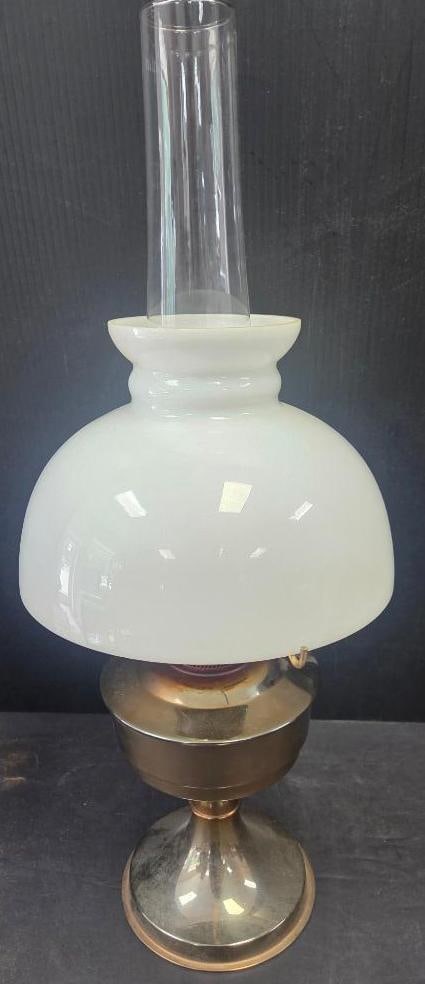 Brass Oil Lamp with Milk Glass Shade: Antique brass oil lamp with white milk glass bell-form shade, clear glass chimney, brass burner with wick-raising mechanism and finger-loop chain, and a footed brass base, approx. 24" H overall.