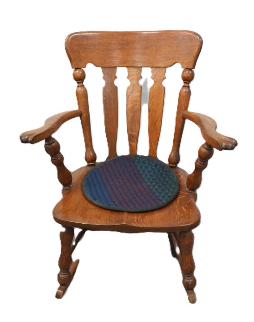 Antique Oak Pressed-Back Rocking Armchair: Antique oak rocking armchair with pressed spindle back, shaped arms, and a rounded seat with a round tapestry cushion, approx. 40" H.