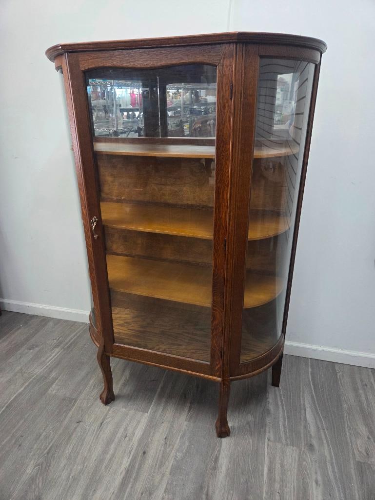 Curved-Glass Oak China Cabinet and Chest of Drawers: Bow-front oak curio/china cabinet with curved glass sides and single glazed door, brass escutcheon and working key, four interior wood shelves (one mirror-backed), cabriole legs with ball-and-claw