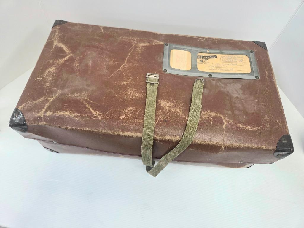Vintage Suitcase with Bundle of 1940s Magazines: Hard-sided fiber suitcase with canvas straps and metal corner guards, maker's tag reading "Herculean, General Fibre Products Co., Fitchburg, Mass.," with a handwritten period shipping label (Philip